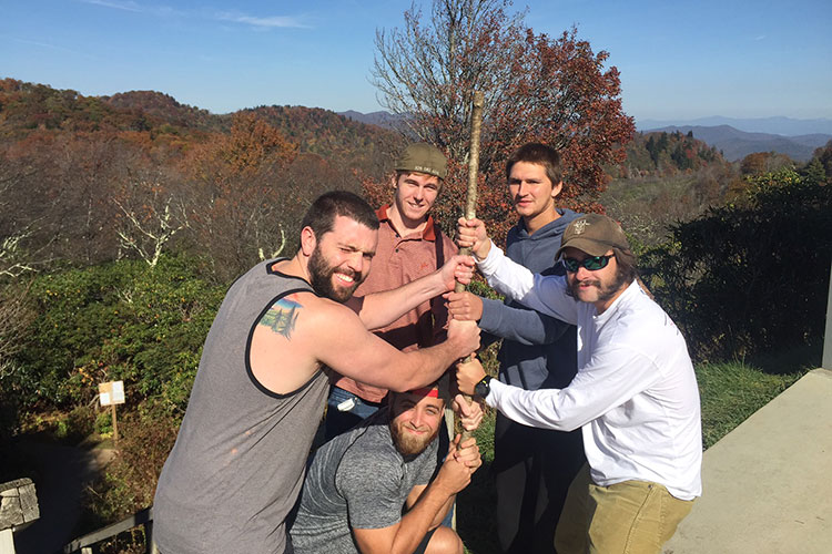 men posing with hiking stick