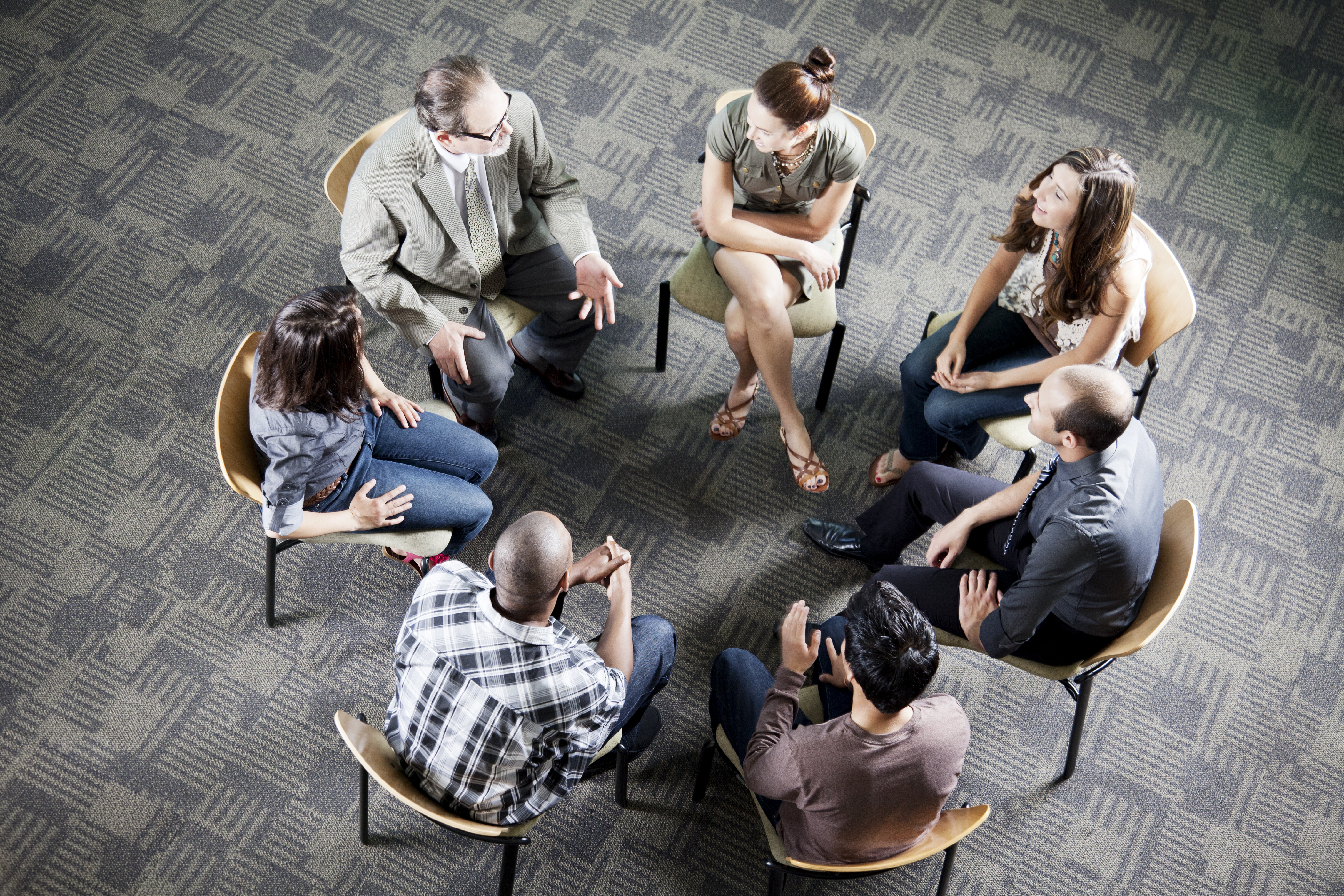 group of people talking in circle