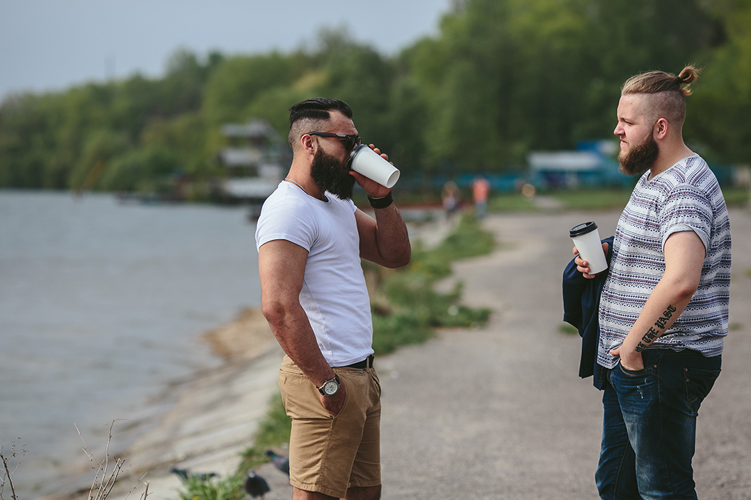 two men chat over coffee