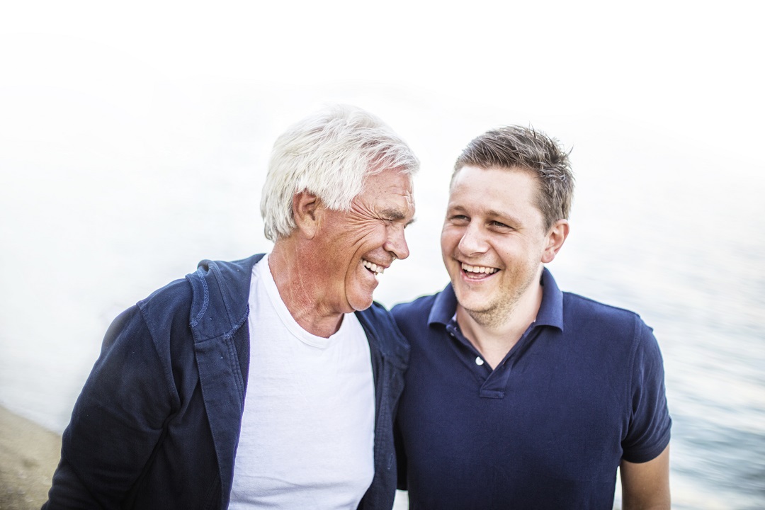 older man and younger man laugh together