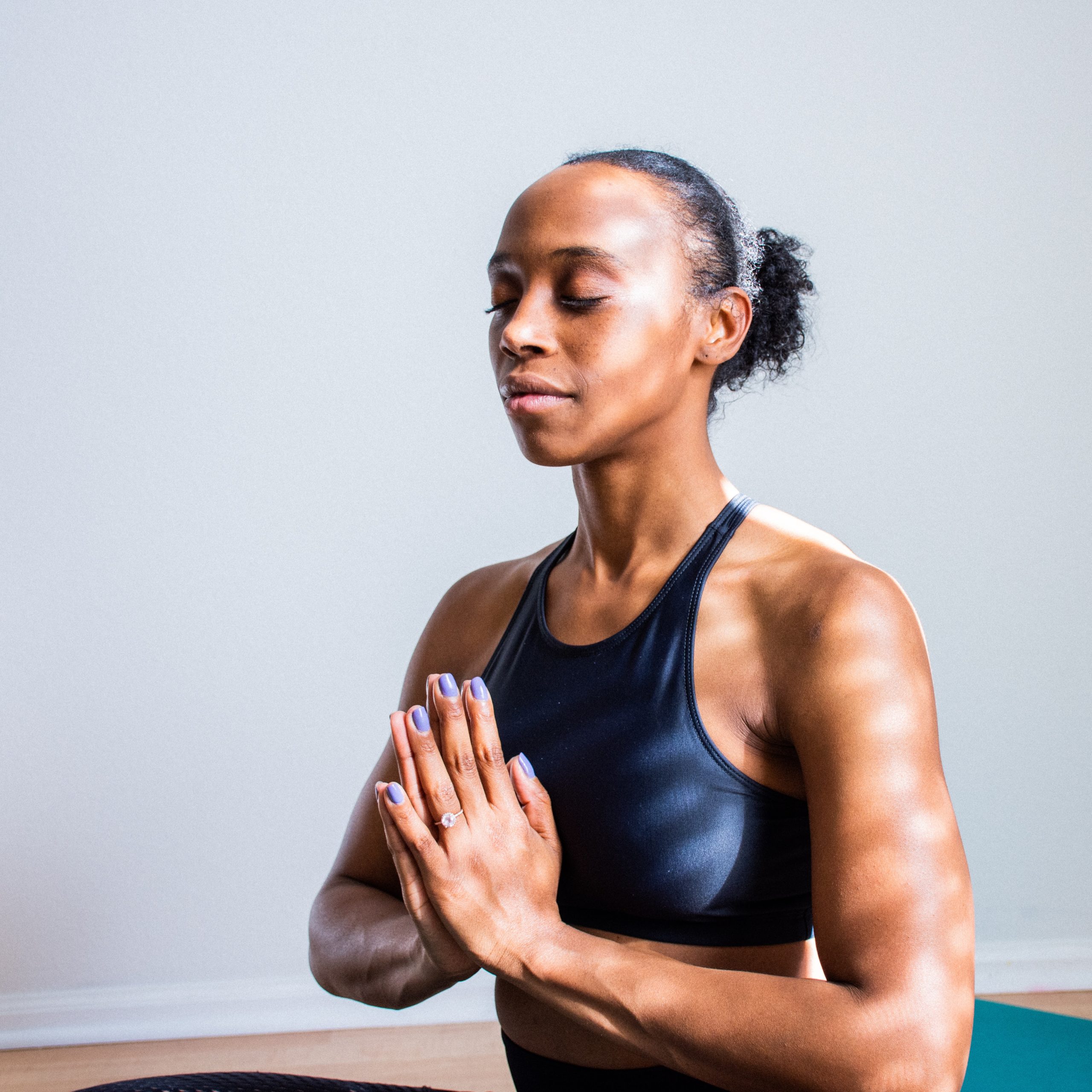 Woman with closed eyes concentrating during yoga pose