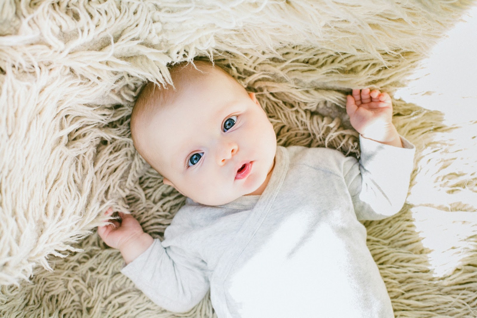 Close up of baby laying on a rug