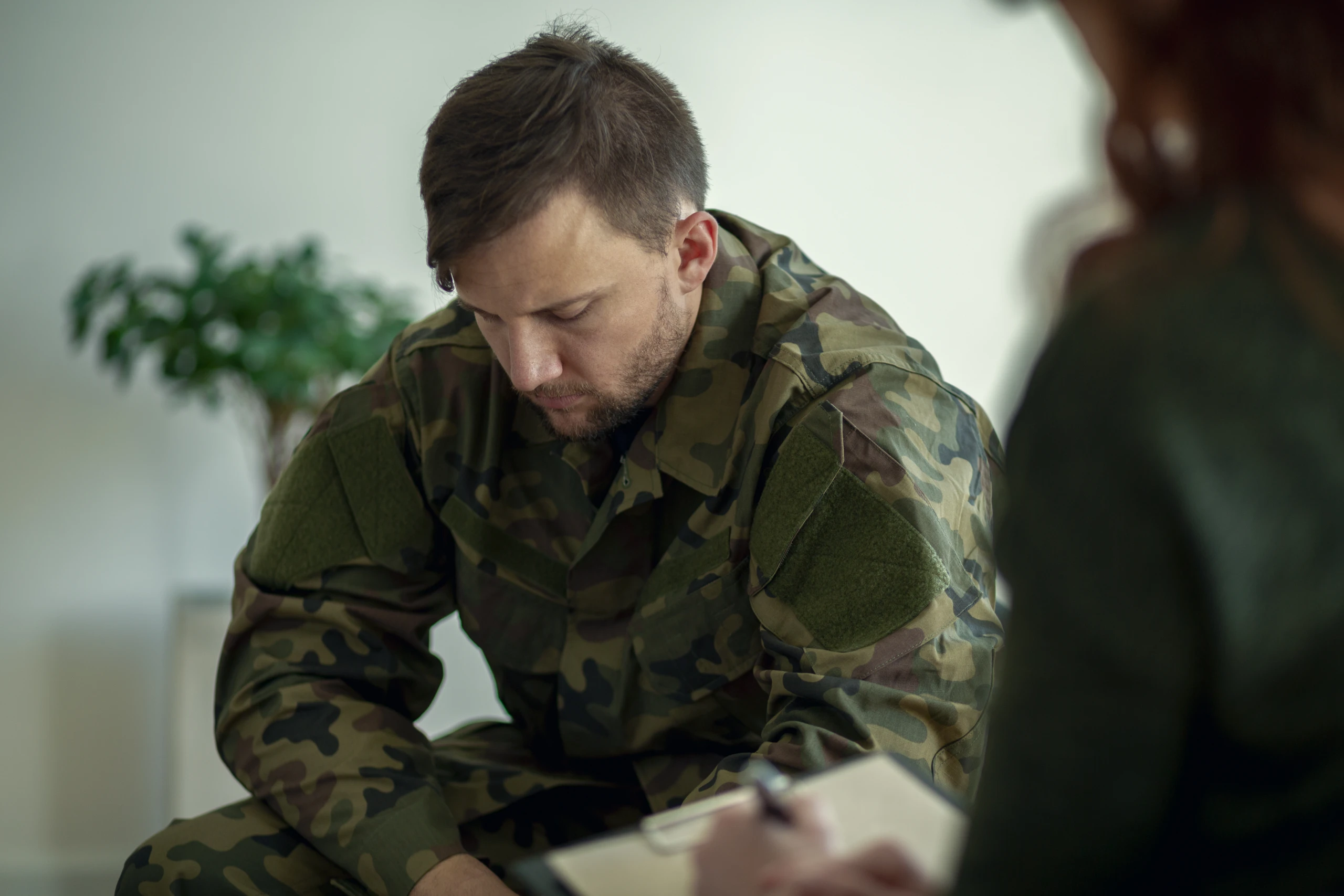 Soldier sitting and talking to his therapist